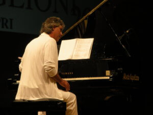 Italian Singer Andrea Bocelli playing piano